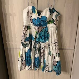 Aje Maya botanical tiered mini floral dress with pockets. Color: Cool Camellia.